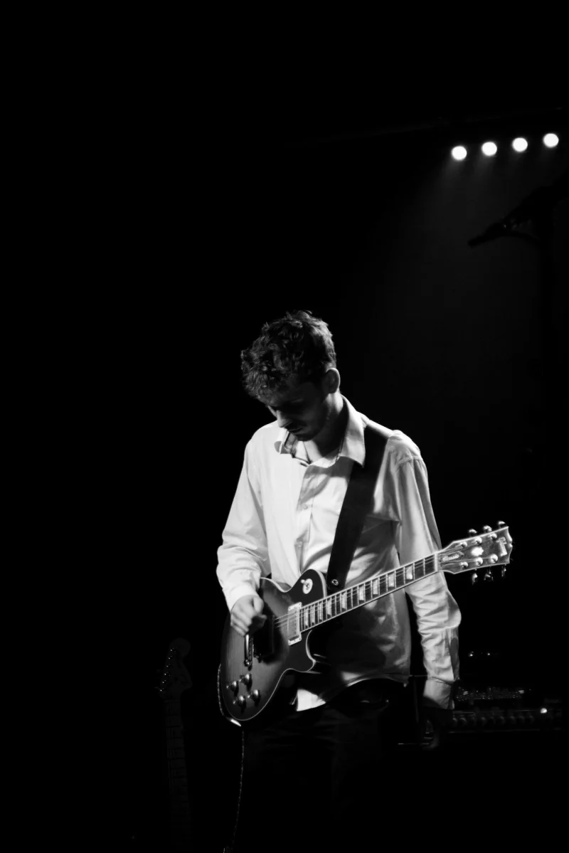 Joel Sharp playing electric guitar on stage