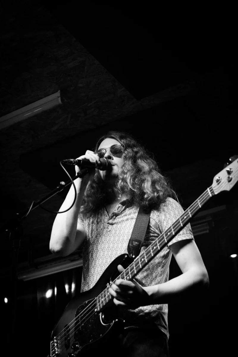 Nathan Mabey singing and playing bass on stage